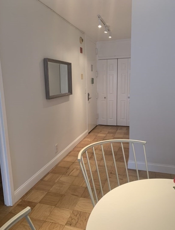 65 East India Row, Unit 10A Boston, MA 02110 - Photo 10 of 17 a view of a door and chair in a room