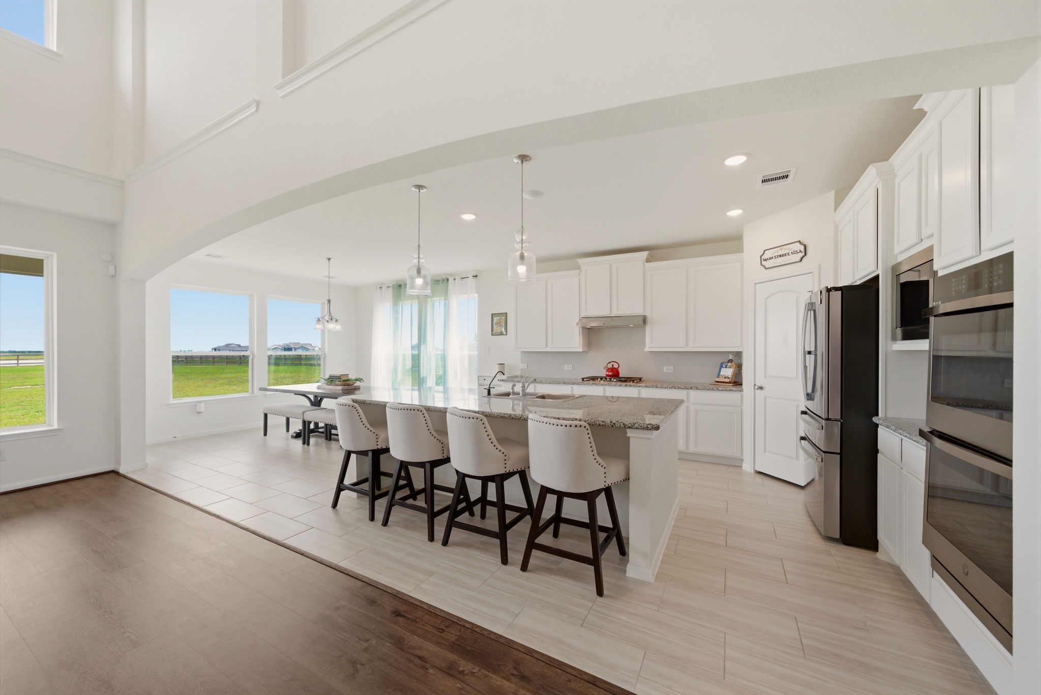 4012 Edgewater Ter Lane Waller, TX 77484 - Photo 14 of 42 a kitchen with a table chairs refrigerator and microwave