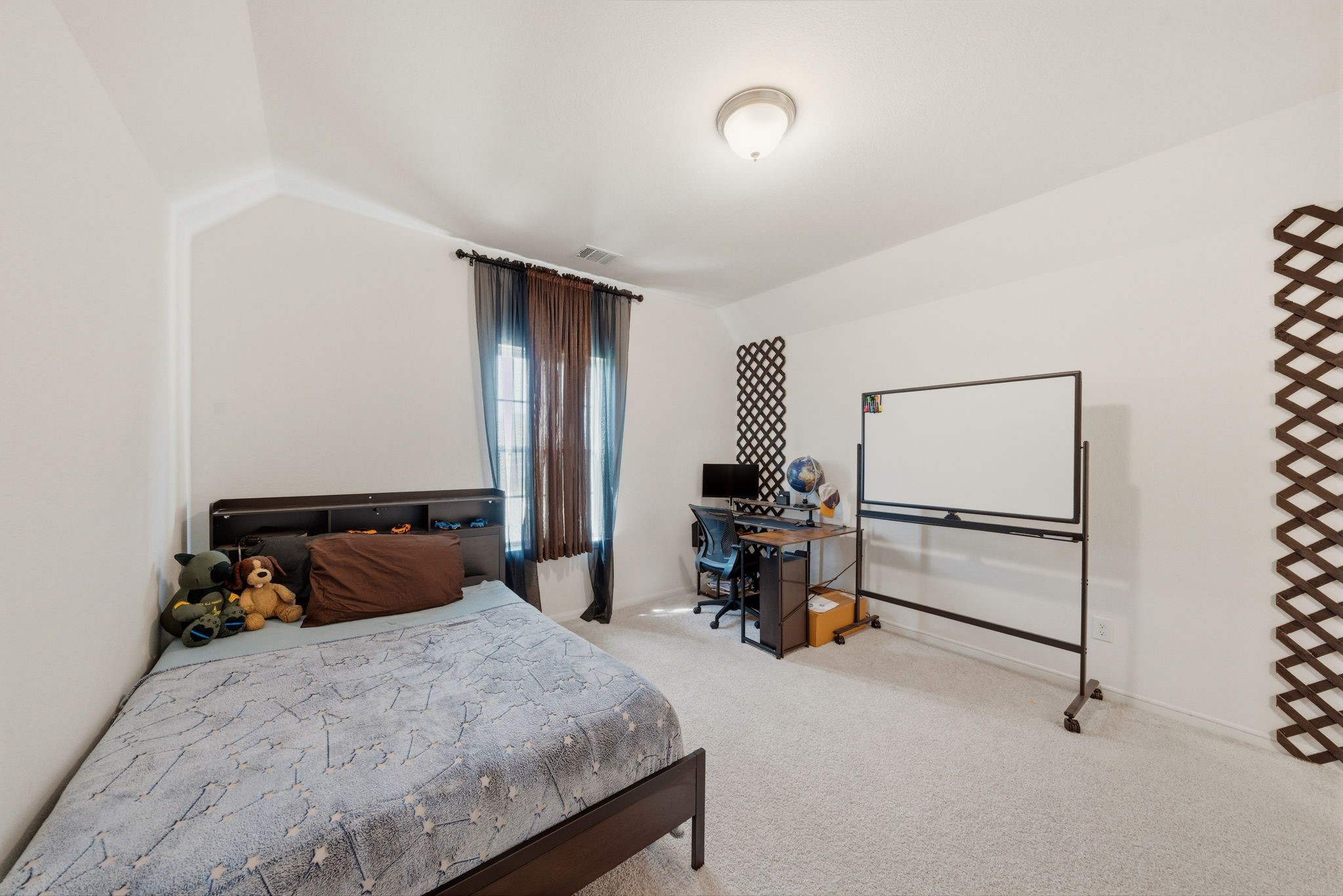 4012 Edgewater Ter Lane Waller, TX 77484 - Photo 26 of 42 a bedroom with a bed a table and painted walls