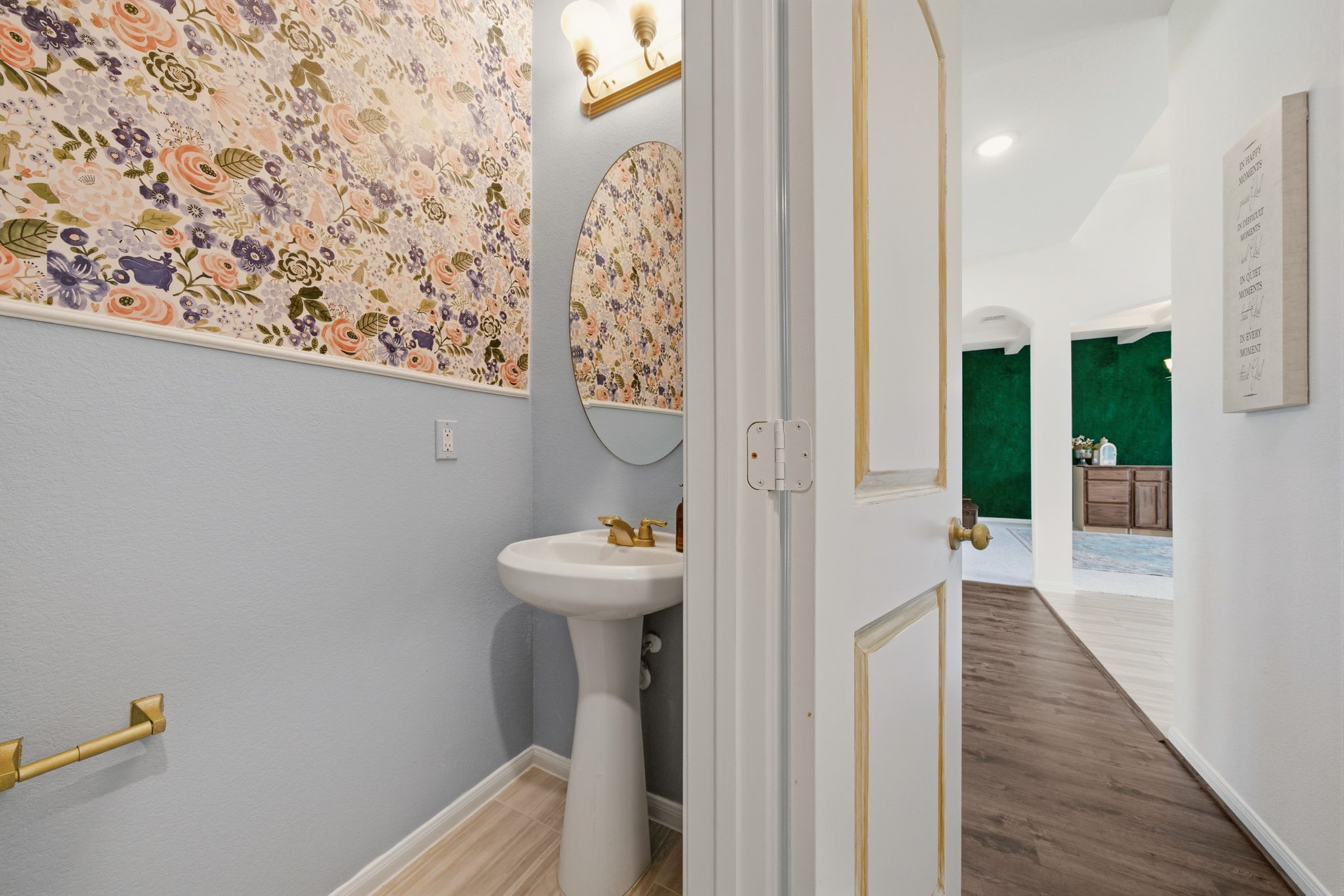 4012 Edgewater Ter Lane Waller, TX 77484 - Photo 29 of 42 a view of a hallway with wooden floor and a bathroom