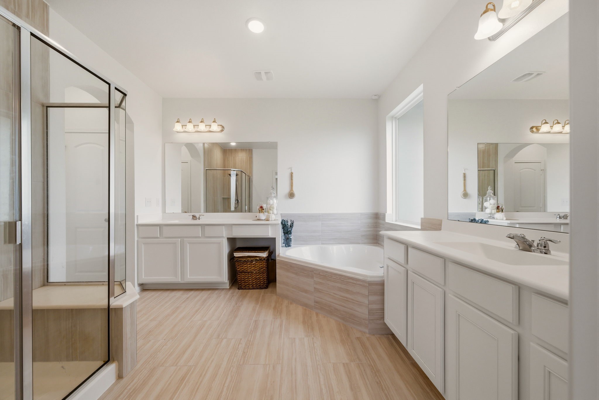 4012 Edgewater Ter Lane Waller, TX 77484 - Photo 30 of 42 a large bathroom with a double vanity sink a mirror and a bathtub