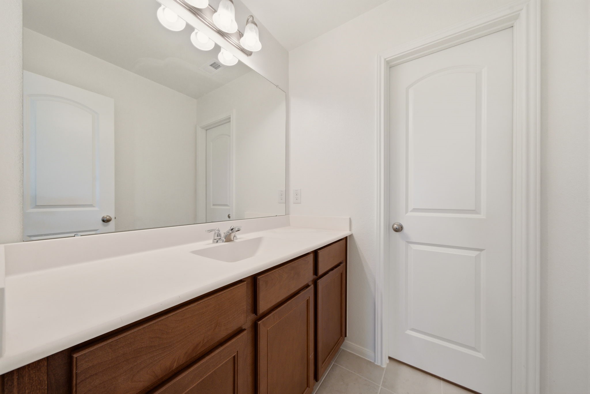 4012 Edgewater Ter Lane Waller, TX 77484 - Photo 33 of 42 a bathroom with a sink a vanity and a mirror