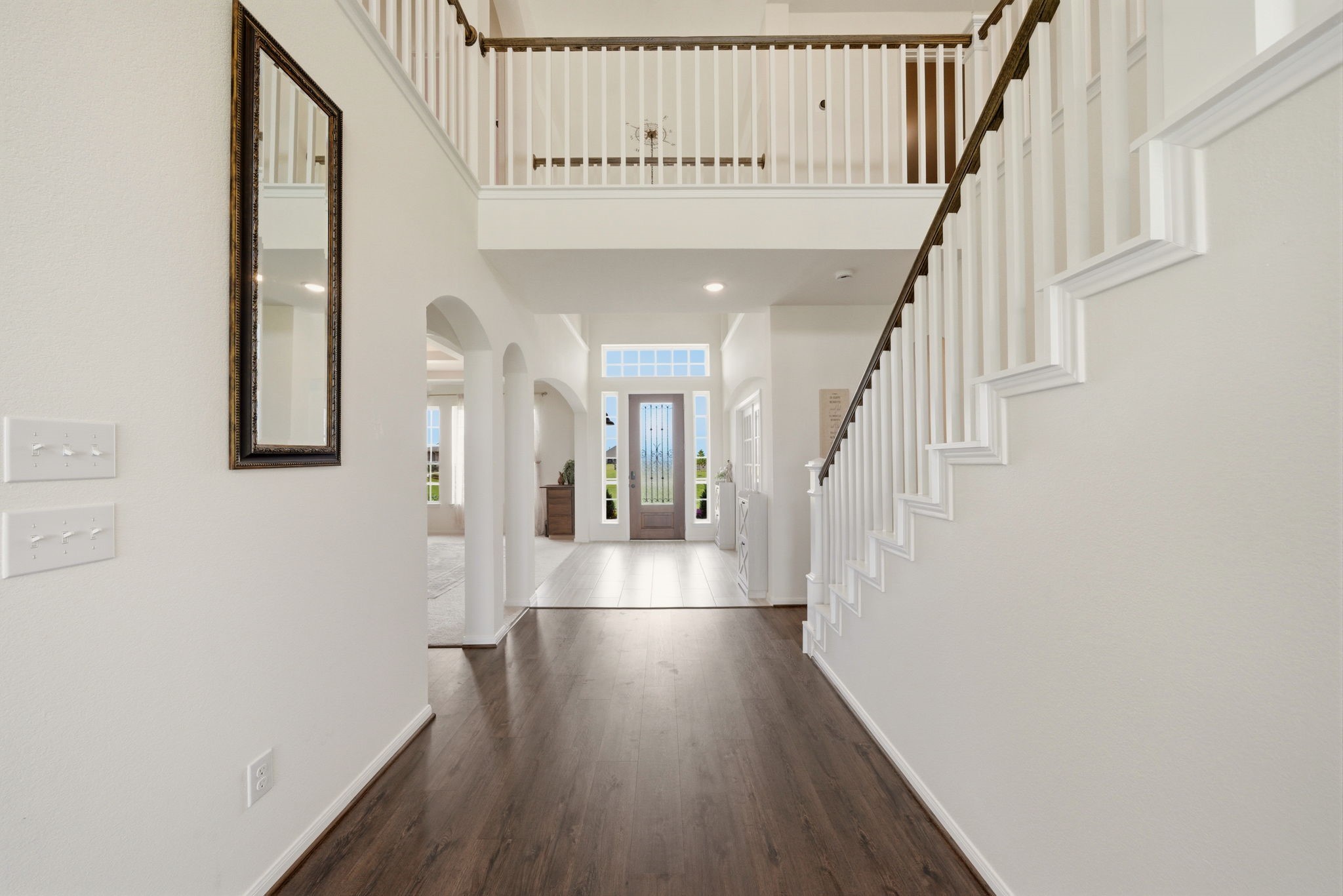 4012 Edgewater Ter Lane Waller, TX 77484 - Photo 9 of 42 a hallway with wooden floor chandelier and entryway