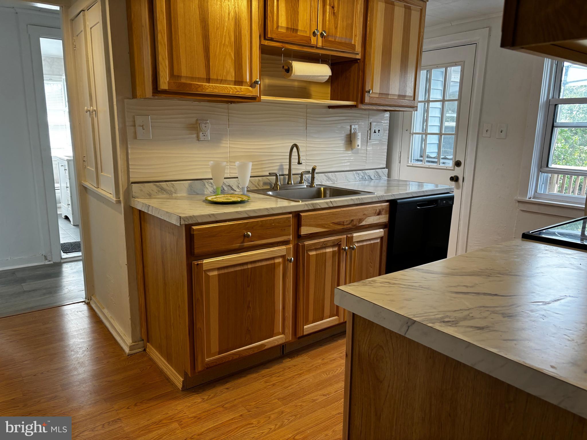 2044 Mill Road Norristown, PA 19403 - Photo 11 of 55 a kitchen with stainless steel appliances granite countertop a sink stove and microwave