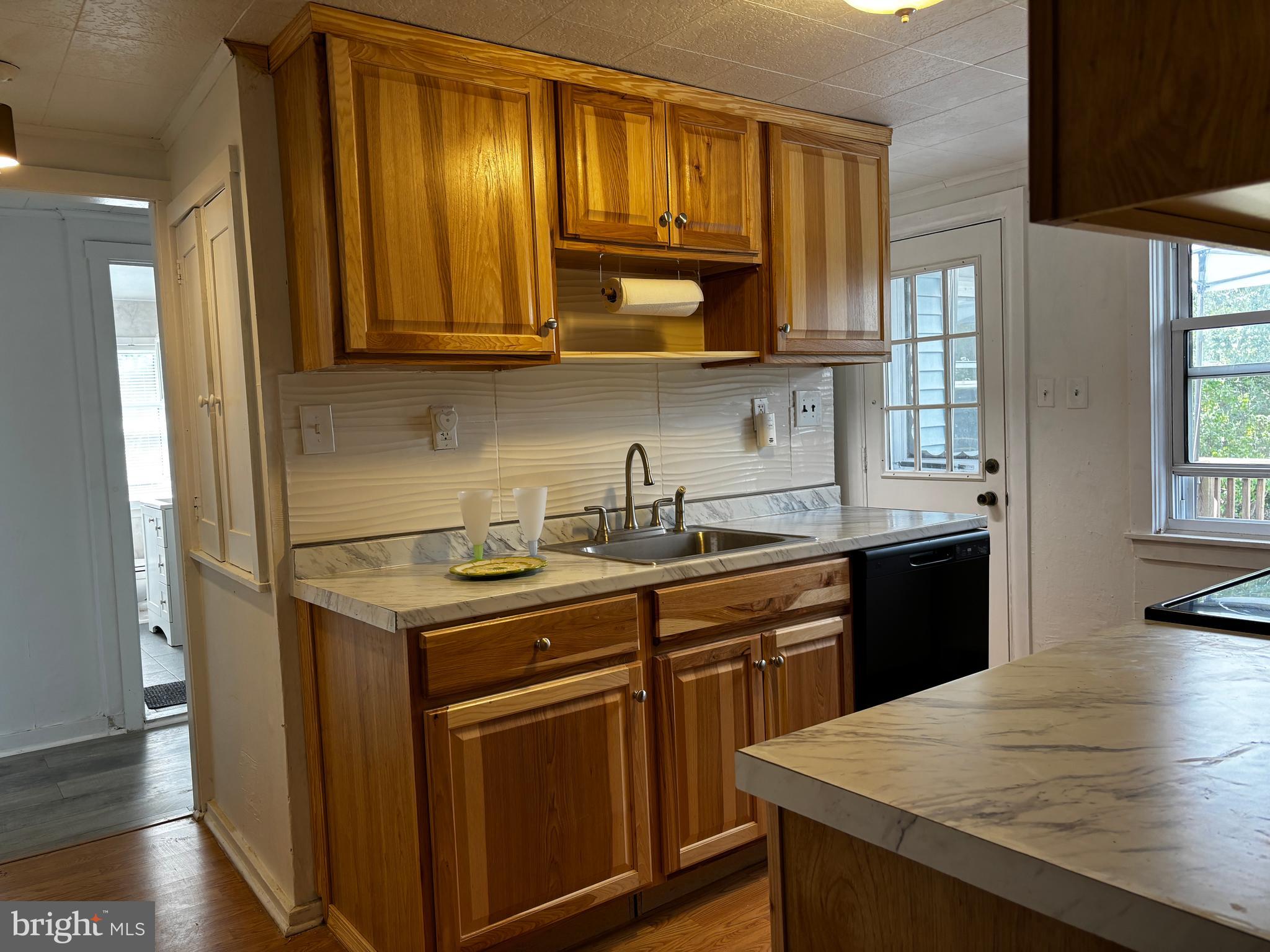 2044 Mill Road Norristown, PA 19403 - Photo 6 of 55 a kitchen with stainless steel appliances granite countertop a sink stove and microwave