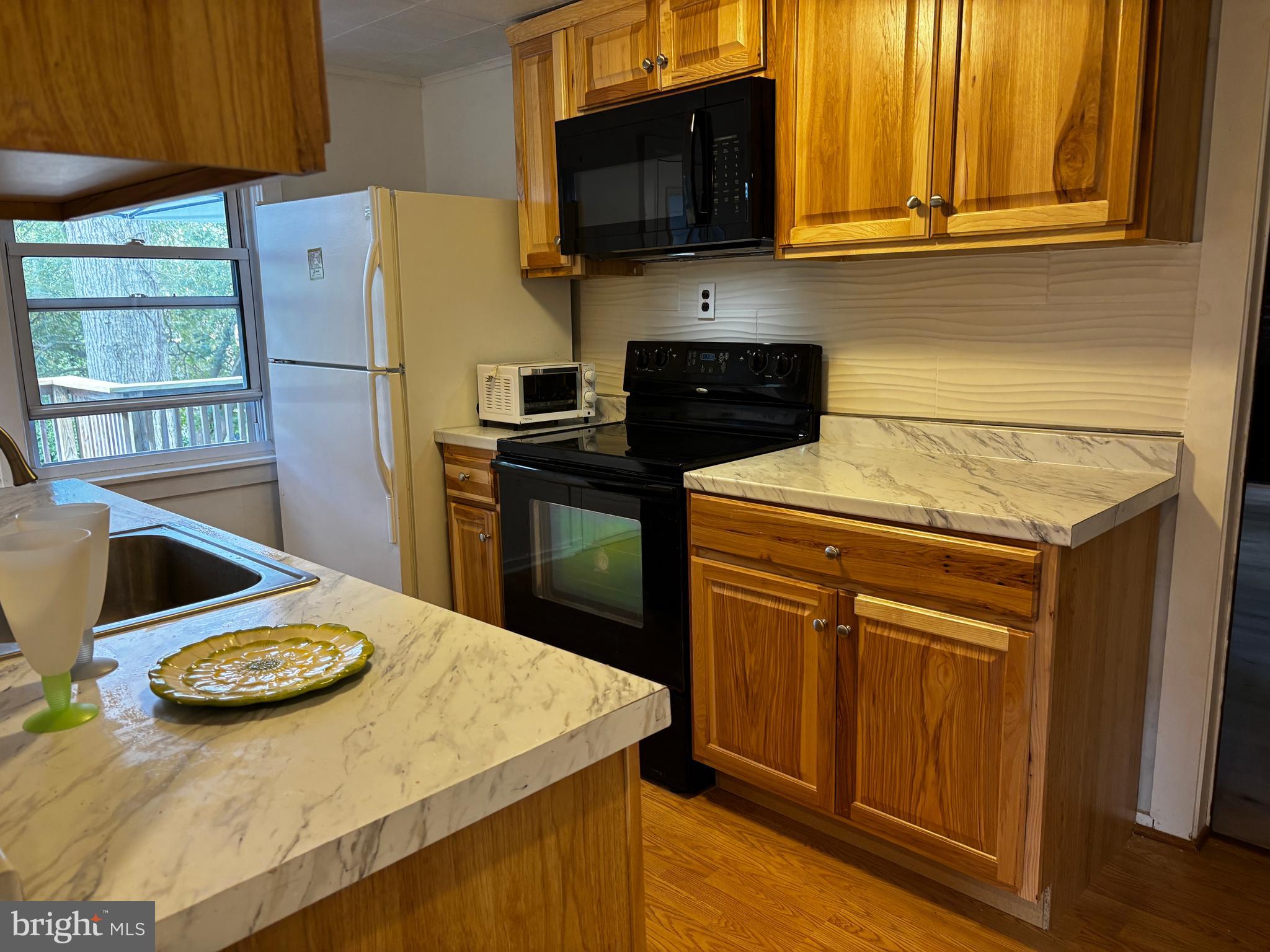 2044 Mill Road Norristown, PA 19403 - Photo 10 of 55 a kitchen with stainless steel appliances a stove a refrigerator a sink a dining table and chairs