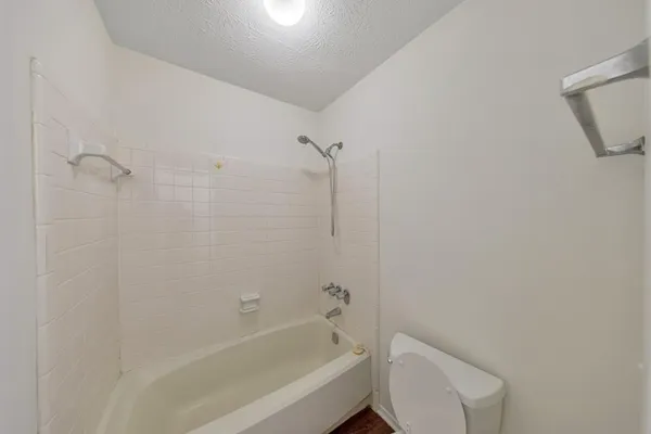 a bathroom with a bathtub and toilet