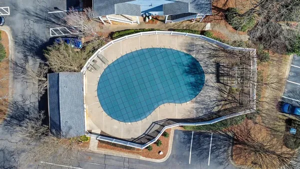an aerial view of a house with a swimming pool