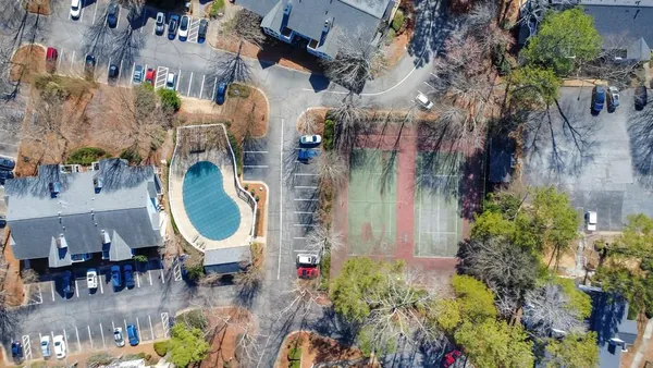 an aerial view of a house with a backyard