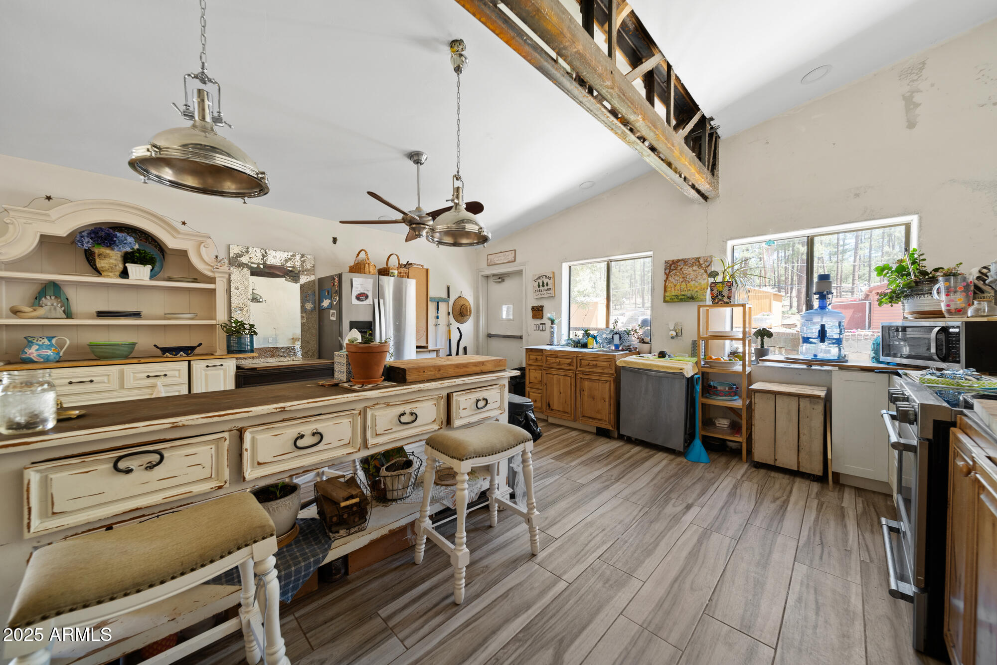 a kitchen with a sink cabinets stainless steel appliances and a counter top space