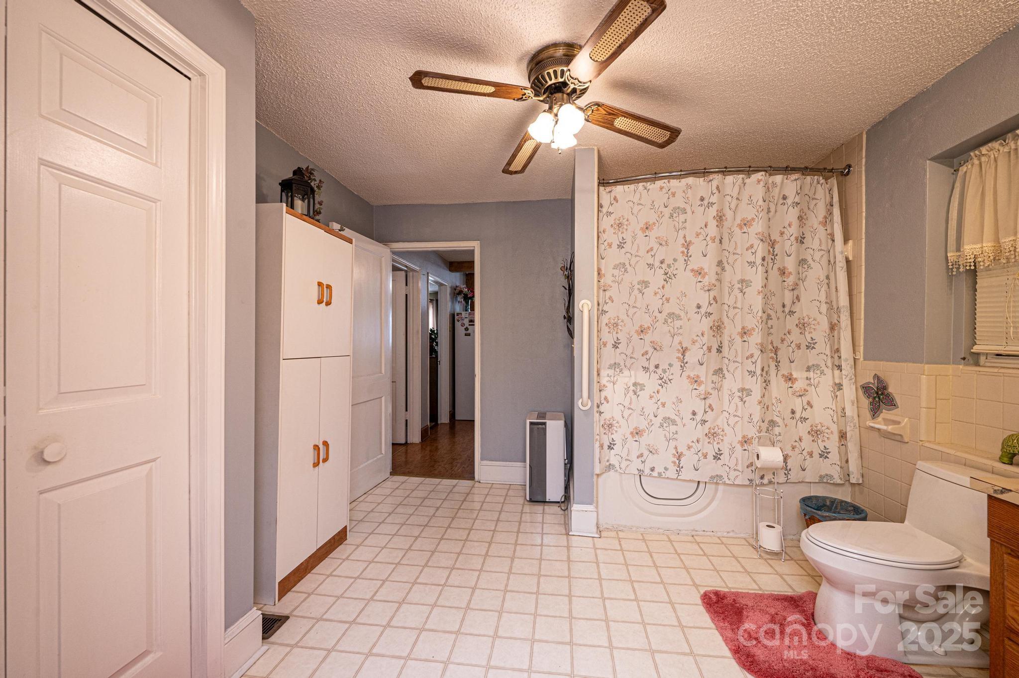 129 38th Street Northwest Hickory, NC 28601 - Photo 12 of 30 a bathroom with a toilet sink and shower