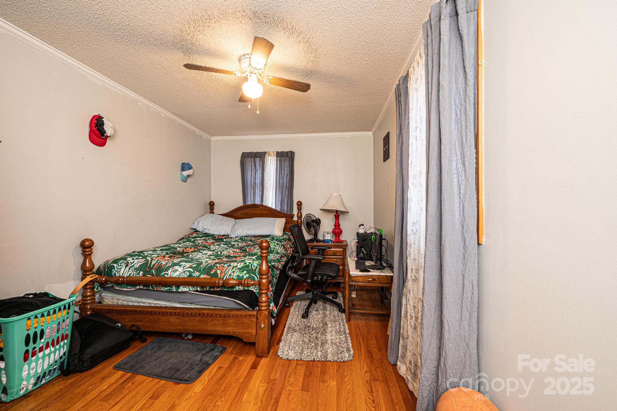 129 38th Street Northwest Hickory, NC 28601 - Photo 14 of 30 a bed room with furniture and a chandelier