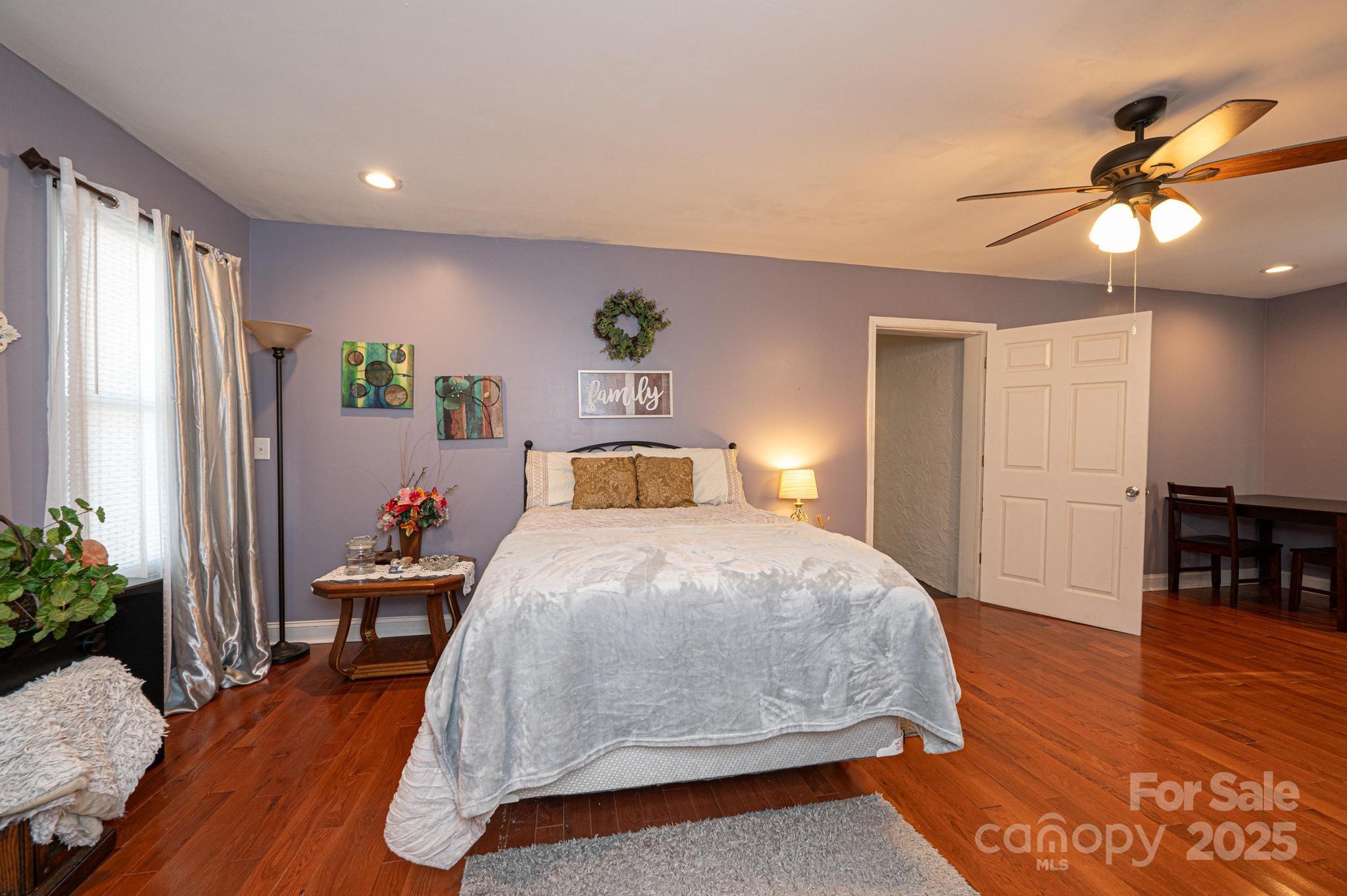 129 38th Street Northwest Hickory, NC 28601 - Photo 19 of 30 a bedroom with a bed and wooden floor