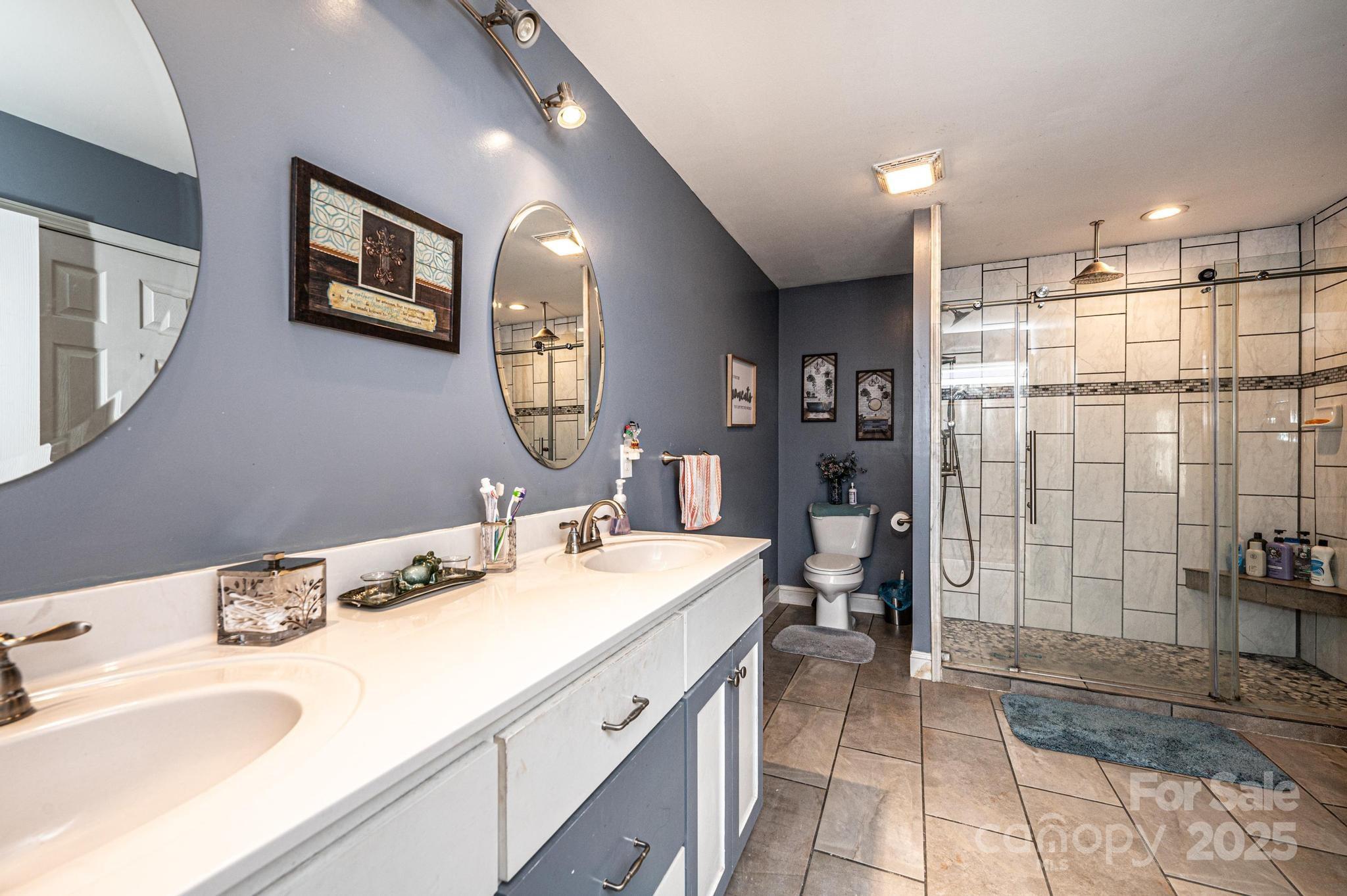 129 38th Street Northwest Hickory, NC 28601 - Photo 21 of 30 a bathroom with a sink double vanity and a shower