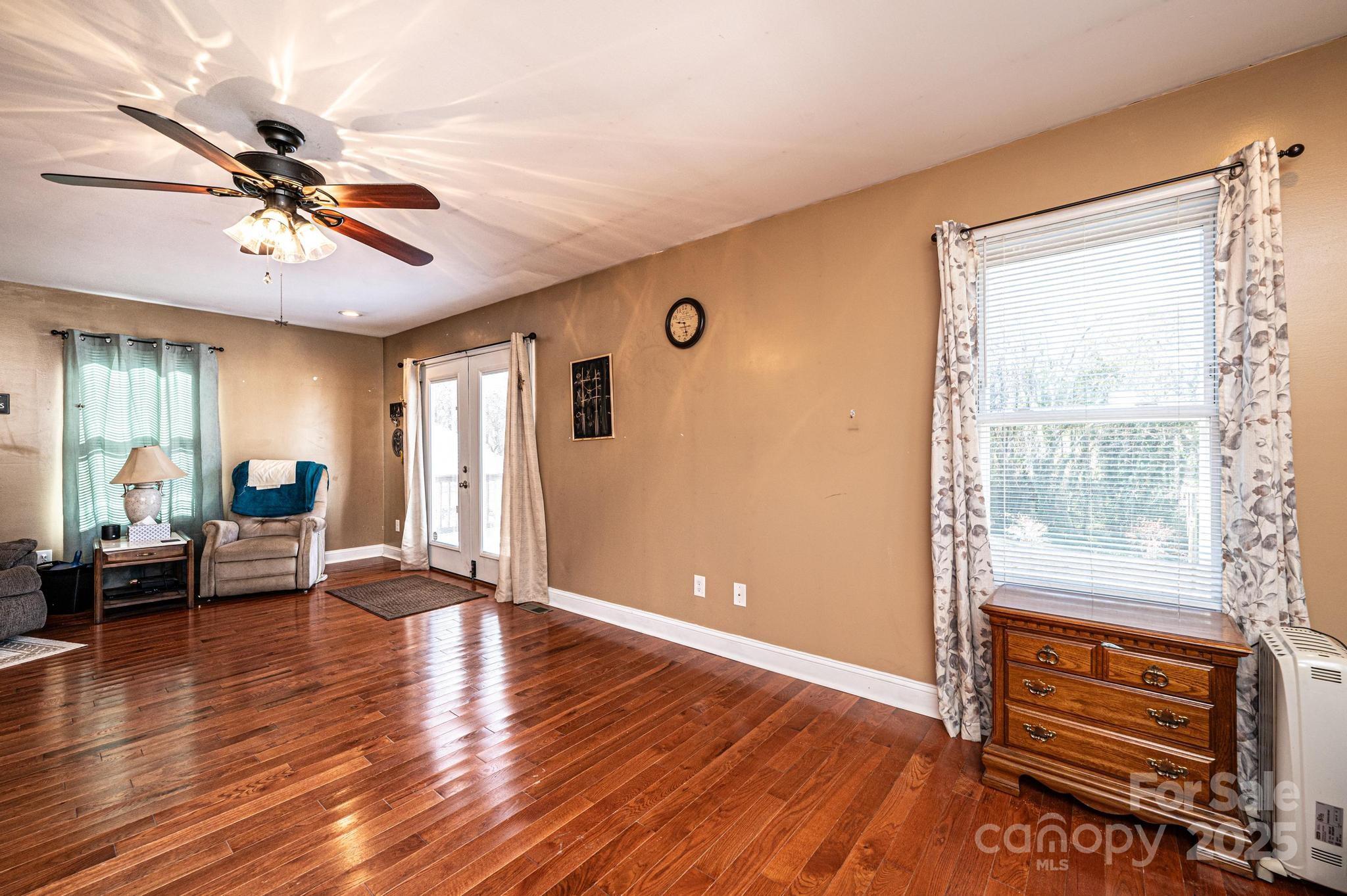 129 38th Street Northwest Hickory, NC 28601 - Photo 25 of 30 a view of an empty room with window wooden floor and a ceiling fan