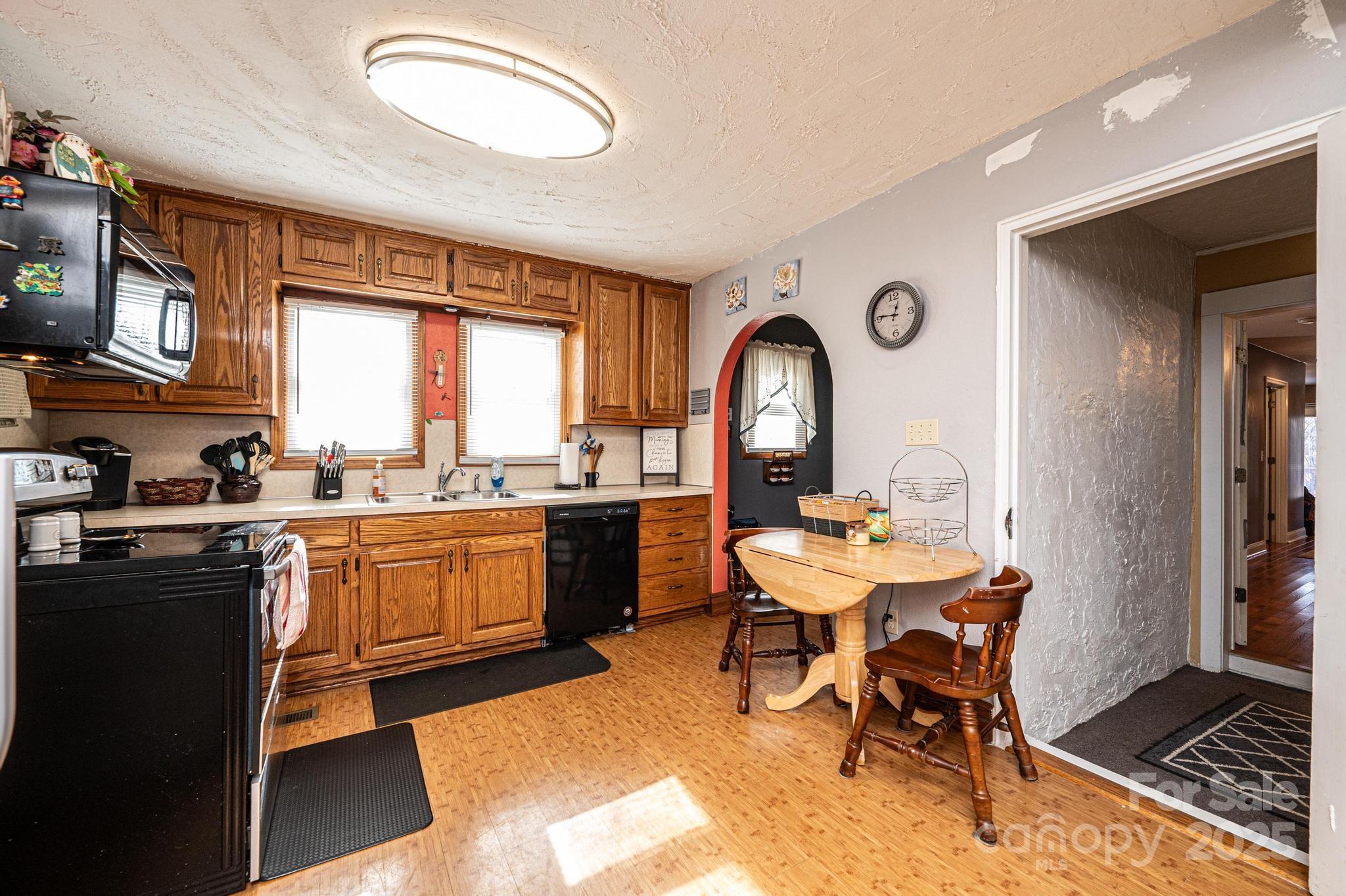 129 38th Street Northwest Hickory, NC 28601 - Photo 7 of 30 a kitchen with a sink a stove a dining table and chairs
