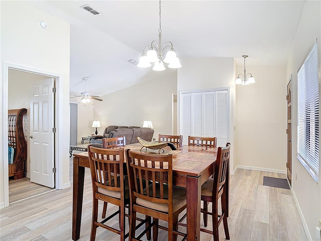 4761 Riverglen Boulevard Ponce Inlet, FL 32127 - Photo 12 of 50 a view of a dining room with furniture and wooden floor