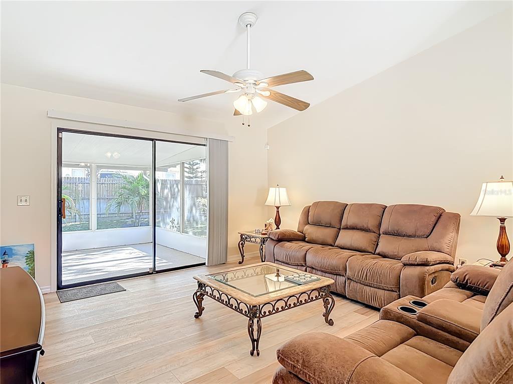 4761 Riverglen Boulevard Ponce Inlet, FL 32127 - Photo 13 of 50 a living room with furniture a ceiling fan and a window