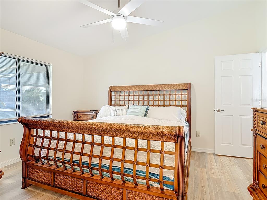 4761 Riverglen Boulevard Ponce Inlet, FL 32127 - Photo 16 of 50 a bedroom with a bed and wooden floor
