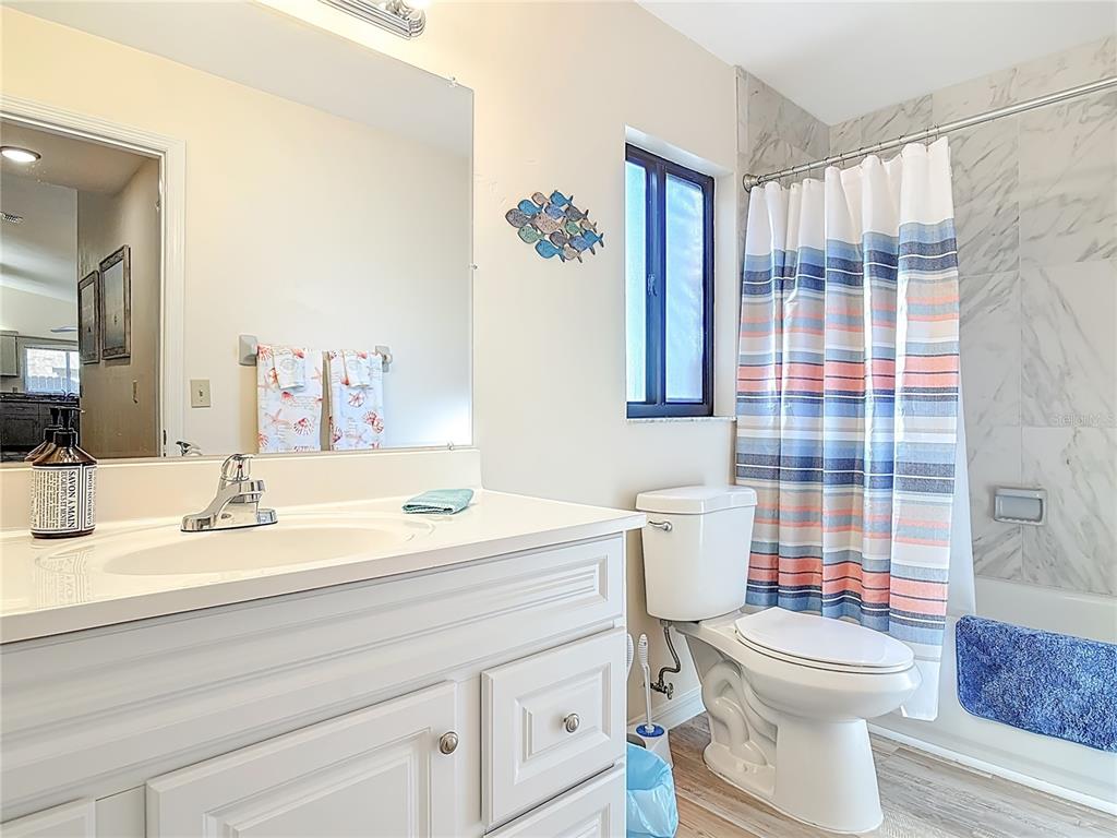 4761 Riverglen Boulevard Ponce Inlet, FL 32127 - Photo 25 of 50 a bathroom with a sink toilet mirror and shower