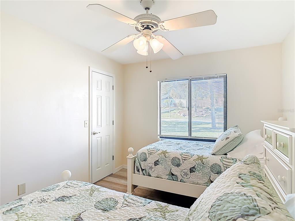 4761 Riverglen Boulevard Ponce Inlet, FL 32127 - Photo 27 of 50 a bedroom with a large bed and a chandelier