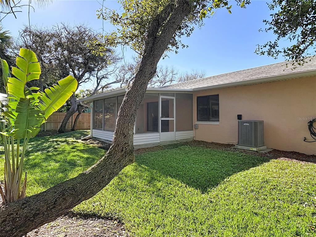 4761 Riverglen Boulevard Ponce Inlet, FL 32127 - Photo 34 of 50 a backyard of a house with lots of green space