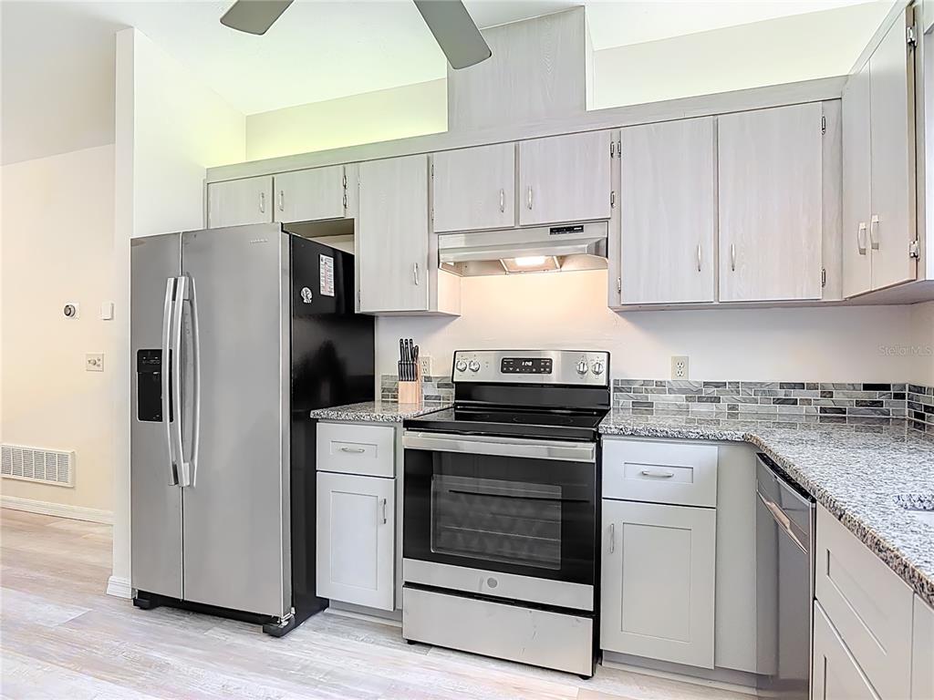 4761 Riverglen Boulevard Ponce Inlet, FL 32127 - Photo 8 of 50 a kitchen with stainless steel appliances granite countertop a stove a refrigerator and a granite counter tops