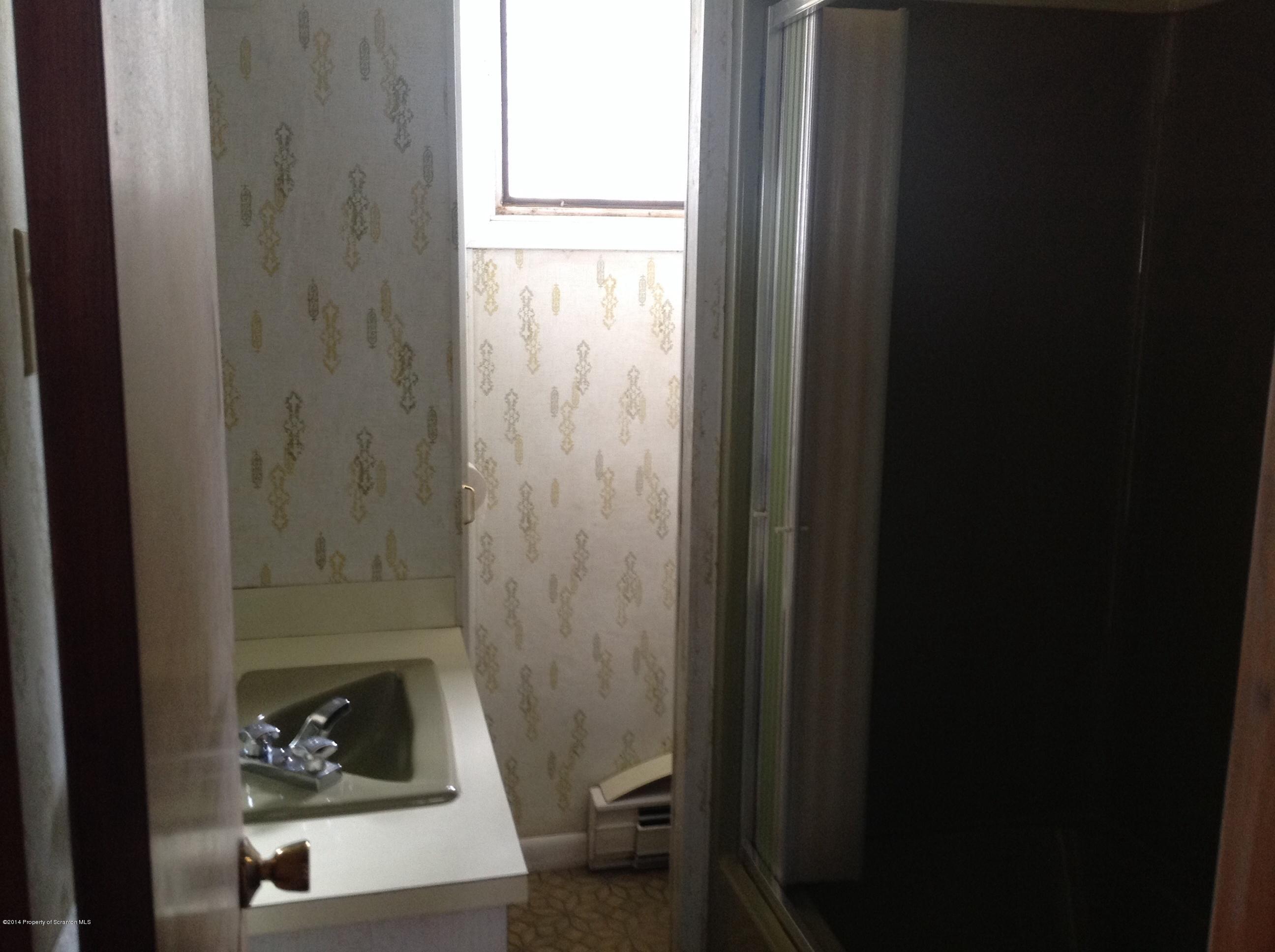303 River Road Falls, PA 18615 - Photo 14 of 15 a white toilet sitting next to a bathroom sink