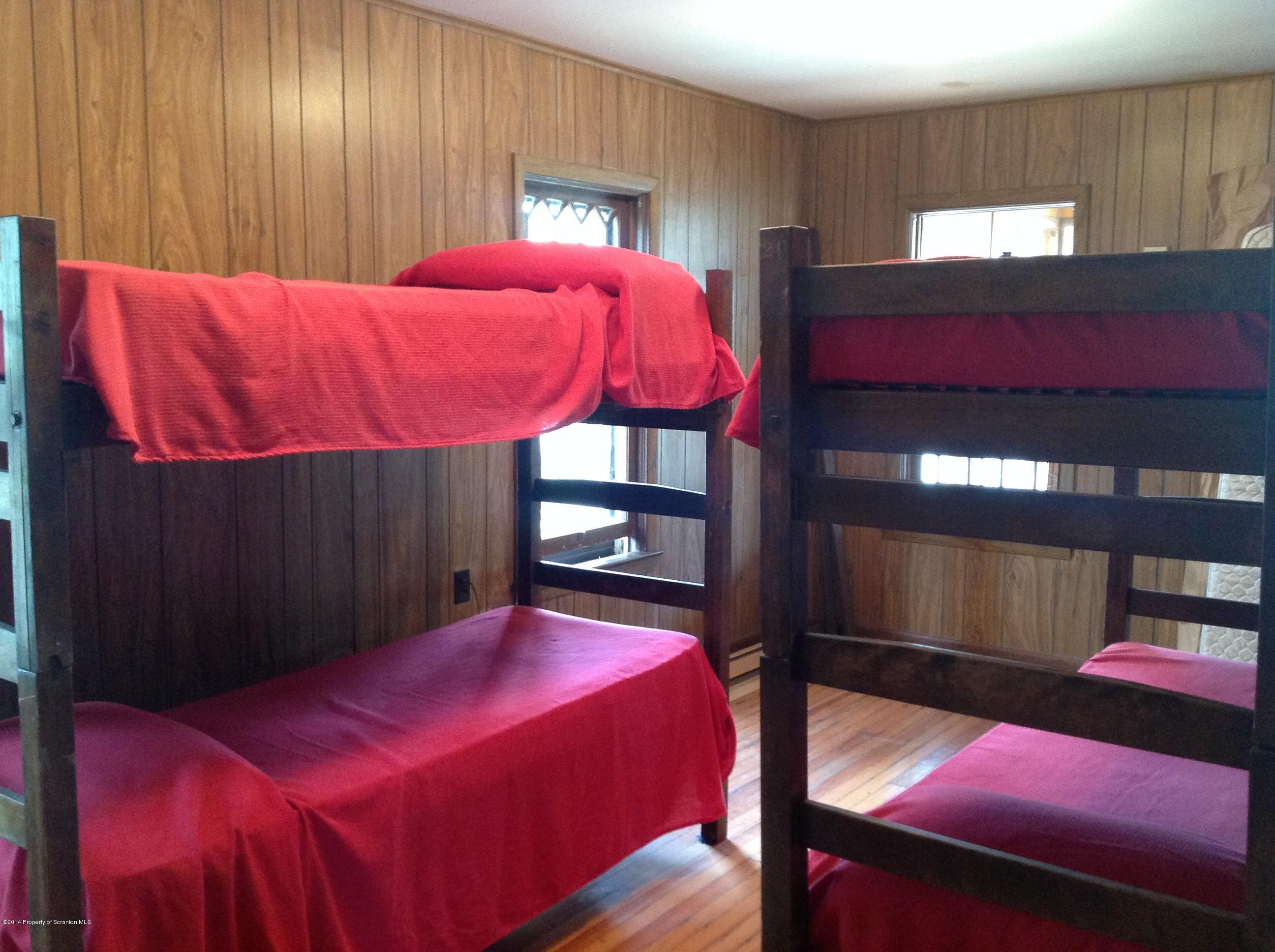 303 River Road Falls, PA 18615 - Photo 7 of 15 a bed sitting in a bedroom next to a window