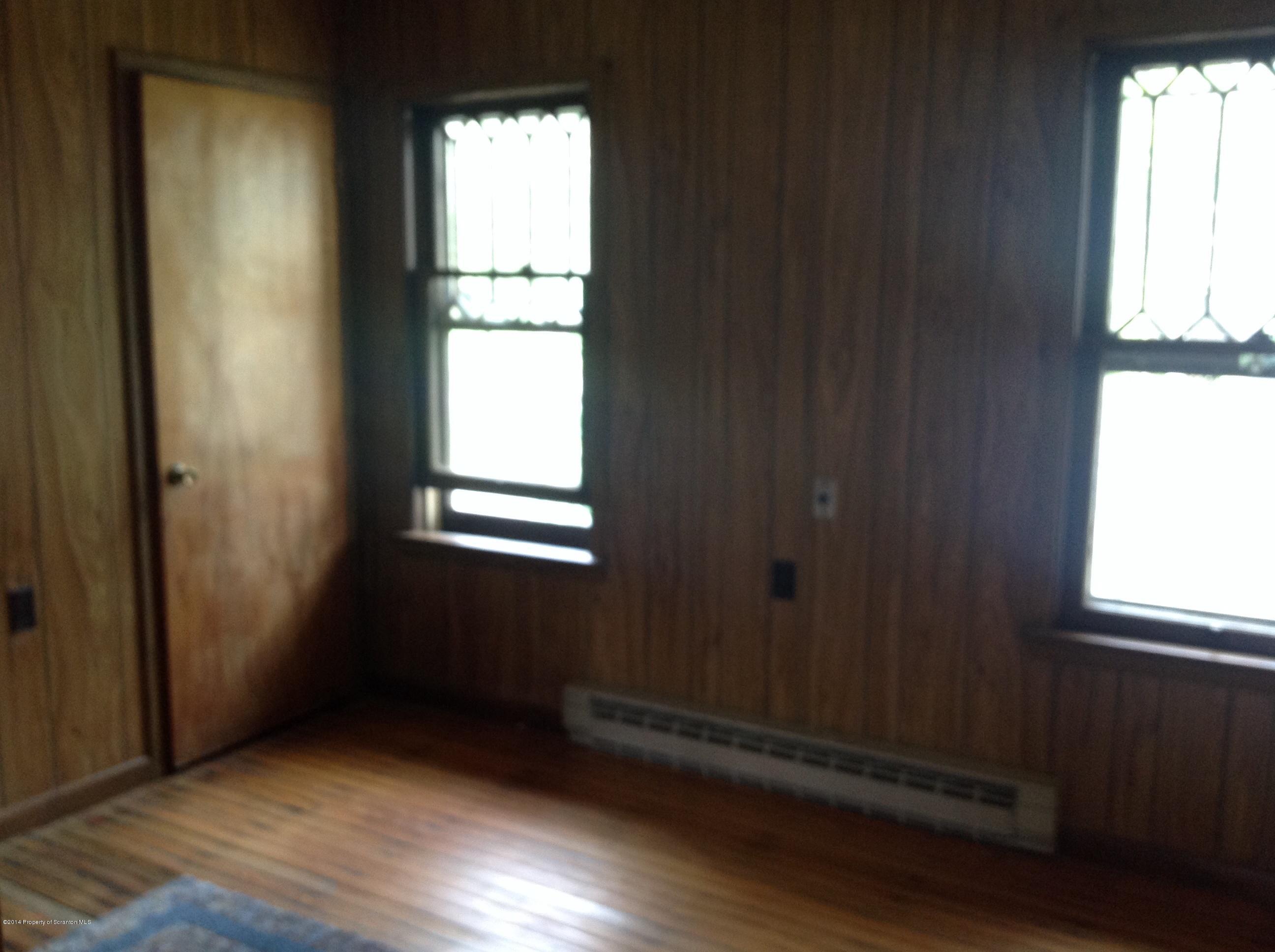 303 River Road Falls, PA 18615 - Photo 8 of 15 an empty room with wooden floor and windows