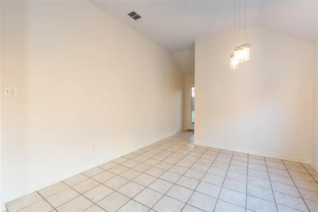 a view of a hallway with wooden cabinets