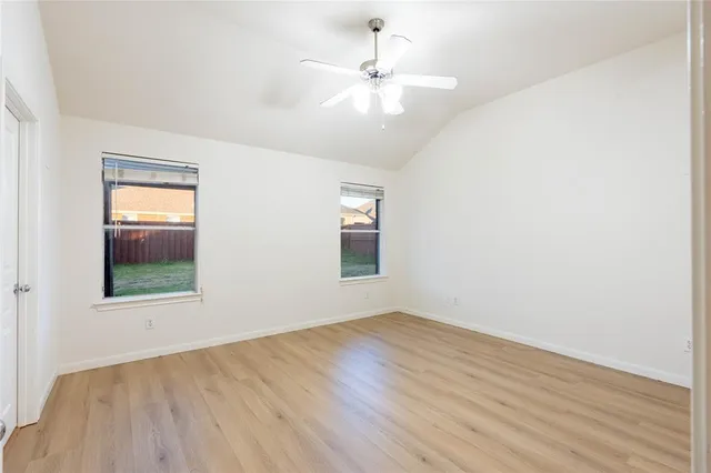 a spacious bathroom with a bathtub sink and mirror