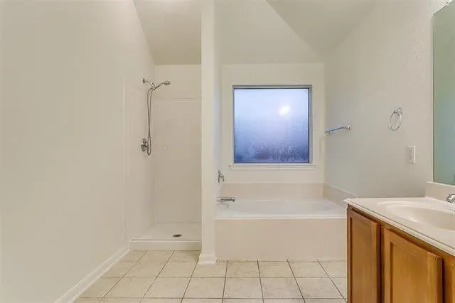 a view of empty room with wooden floor and fireplace