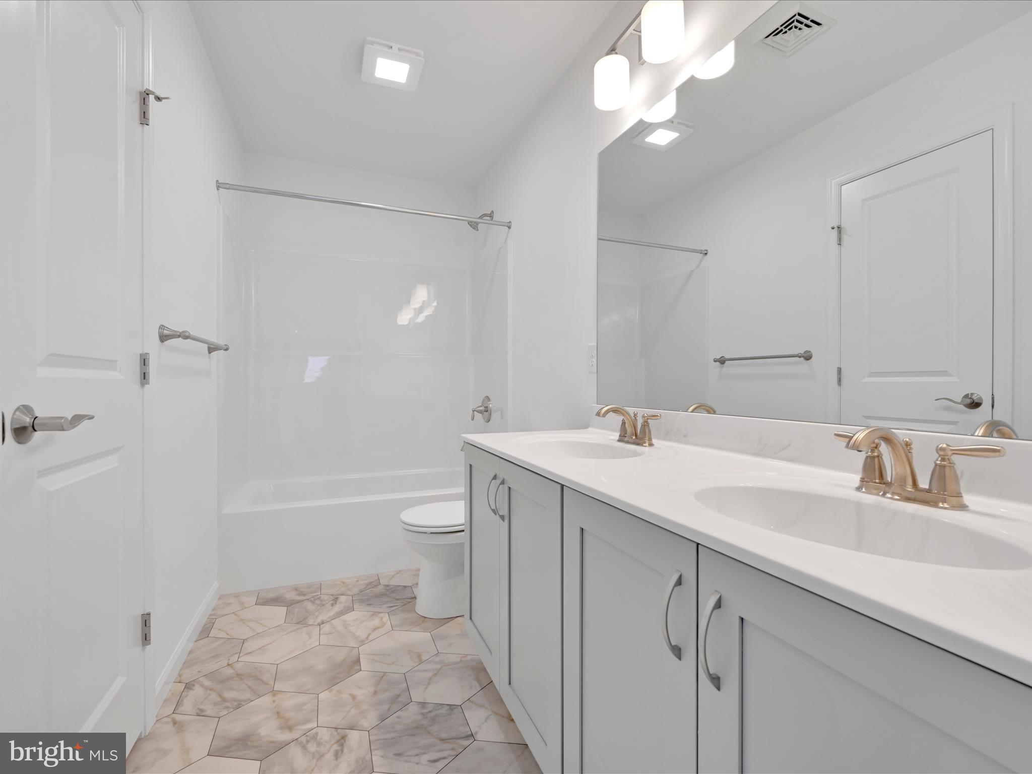 4 Stream Drive Carlisle, PA 17013 - Photo 20 of 39 a bathroom with a sink a toilet and a large mirror