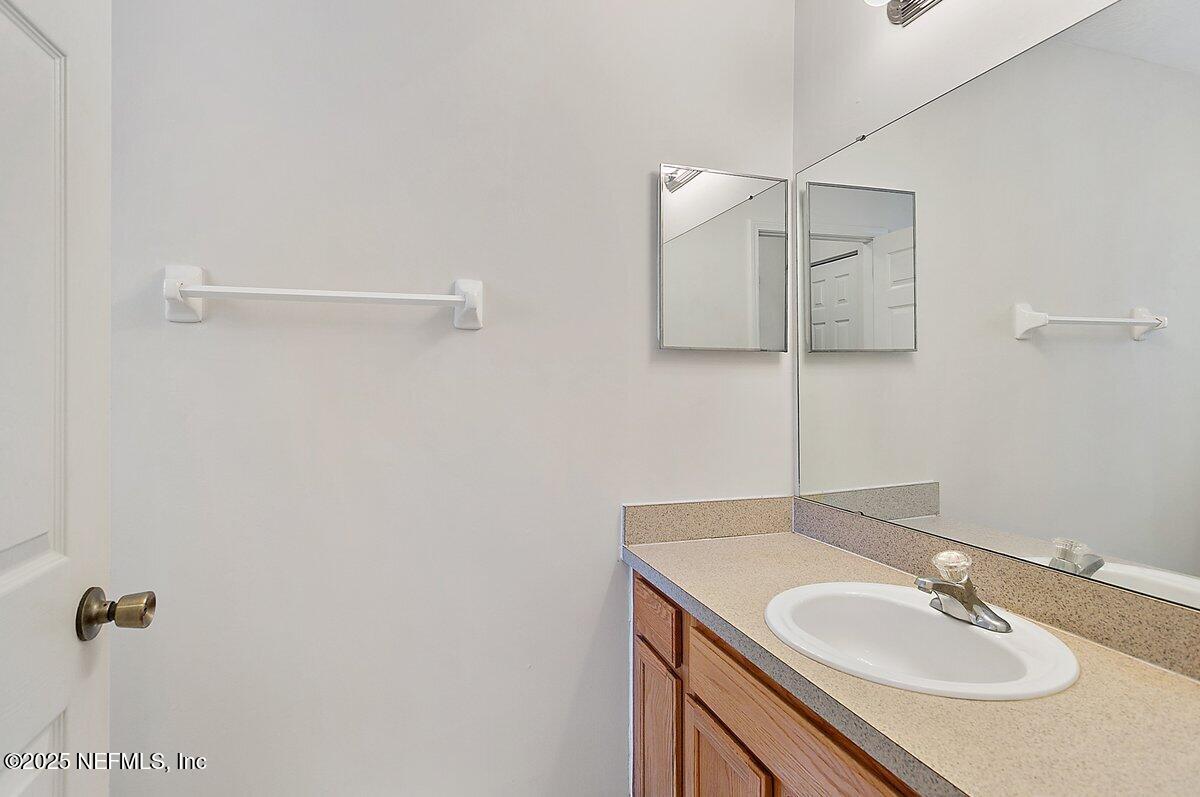 452 Dutton Island Road West Atlantic Beach, FL 32233 - Photo 14 of 28 a bathroom with a sink and a mirror