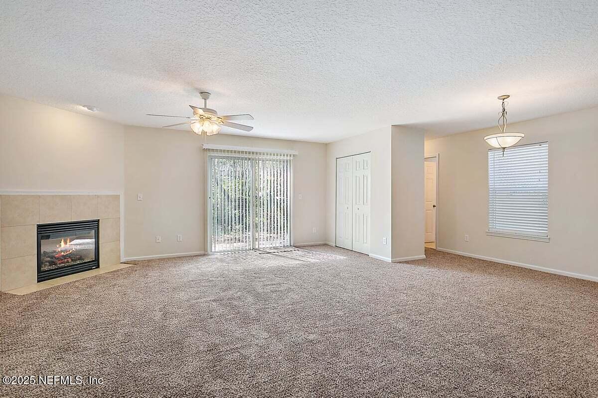452 Dutton Island Road West Atlantic Beach, FL 32233 - Photo 3 of 28 an empty room with windows and fireplace