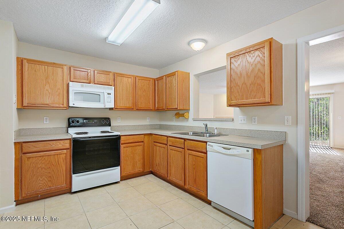452 Dutton Island Road West Atlantic Beach, FL 32233 - Photo 7 of 28 a kitchen with stainless steel appliances granite countertop a stove sink and cabinets