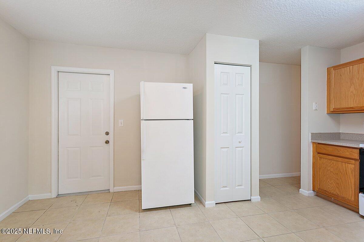 452 Dutton Island Road West Atlantic Beach, FL 32233 - Photo 8 of 28 a view of kitchen with refrigerator cabinets and wooden floor