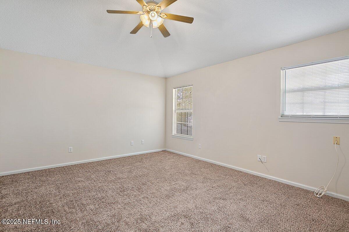 452 Dutton Island Road West Atlantic Beach, FL 32233 - Photo 9 of 28 an empty room with a window and a fan