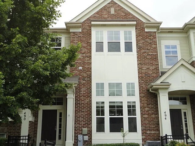 490 Grosvenor Lane Aurora, IL 60504 - Photo 1 of 16 front view of a brick house with a yard