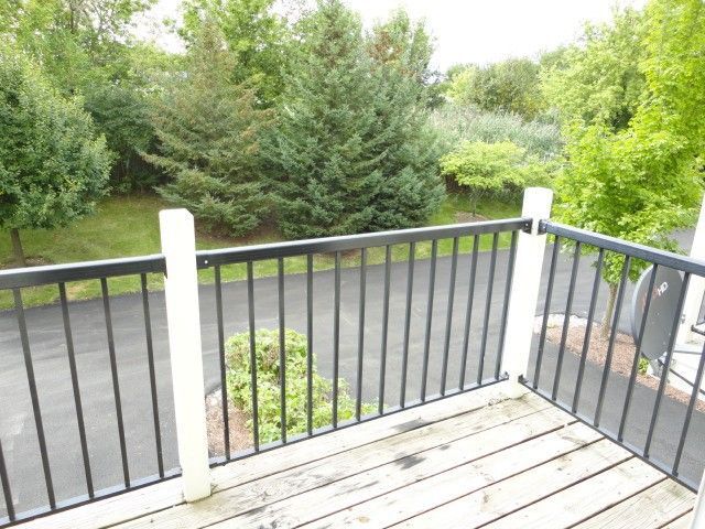 490 Grosvenor Lane Aurora, IL 60504 - Photo 16 of 16 a balcony with trees in front of it