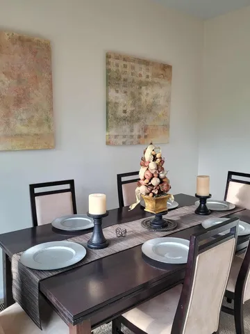 a dining room with furniture and wooden floor