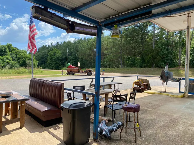 a view of a backyard with furniture and a tree