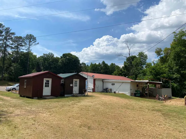 a swimming pool with lots of tress in front of it