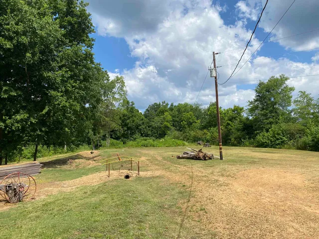 a view of a field with some trees in the background