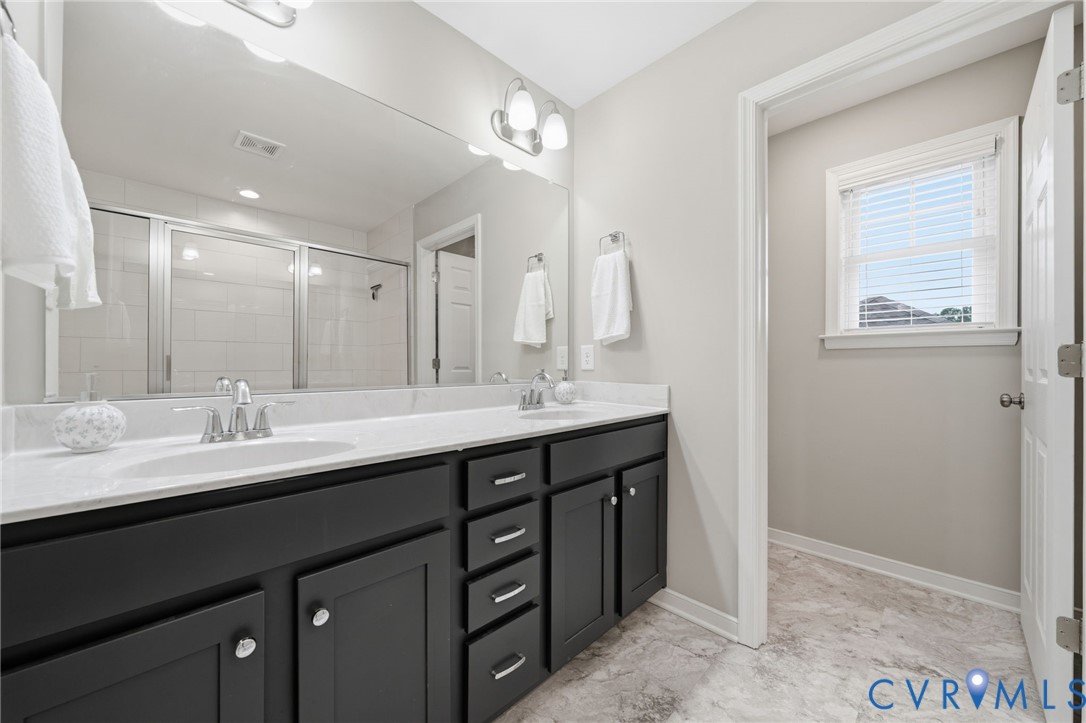 7598 Rural Point Road Mechanicsville, VA 23116 - Photo 24 of 41 a bathroom with double sink and a mirror