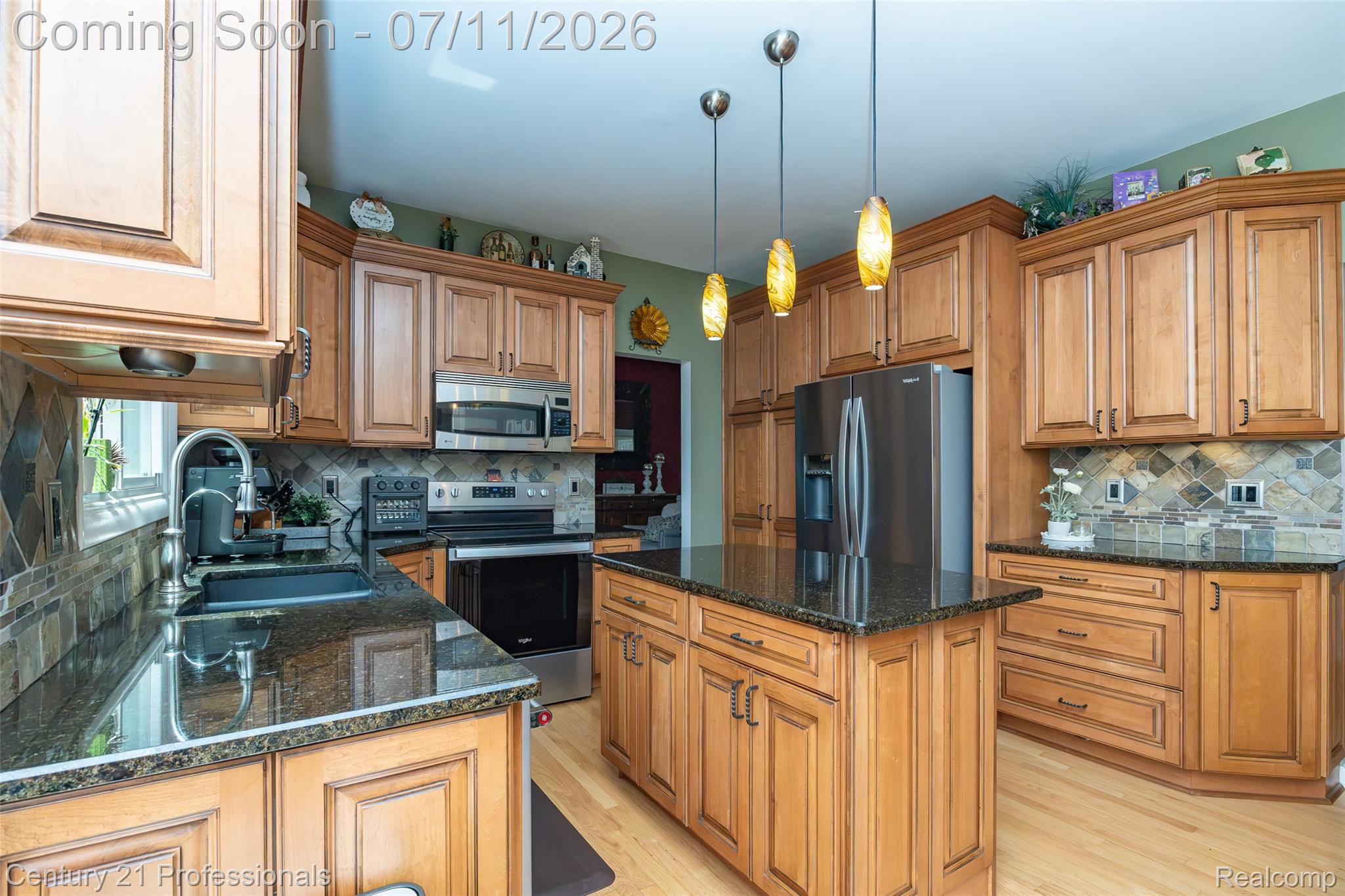 689 Woodfield Way Rochester, MI 48307 - Photo 13 of 61 Kitchen featuring honey-toned wood cabinetry, dark granite countertops, and stainless steel appliances