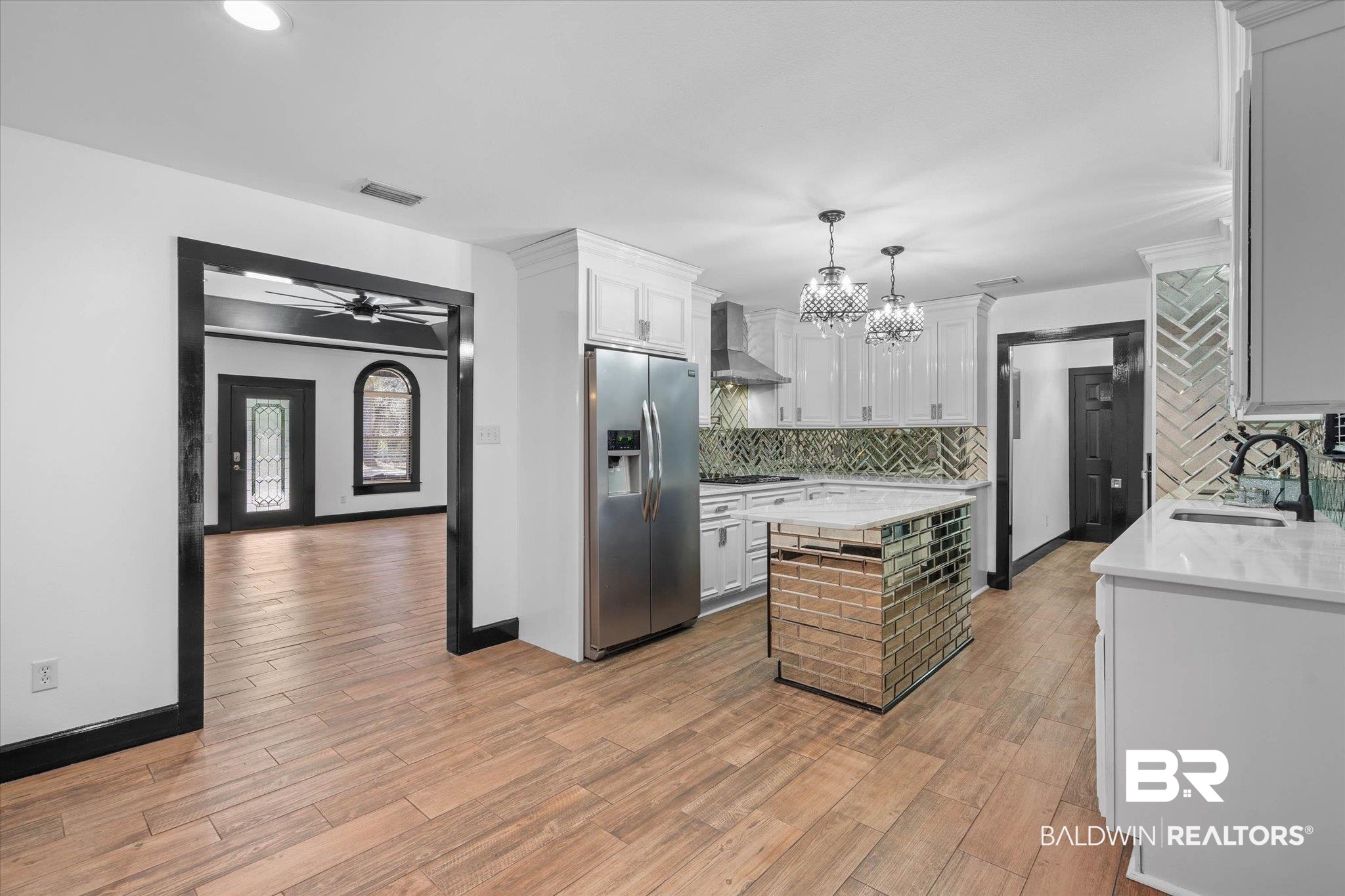 3216 Bay Booster Club Road Theodore, AL 36582 - Photo 6 of 46 Kitchen featuring light stone countertops, stainless steel appliances, light wood finished floors, a ceiling fan, and two tone color scheme