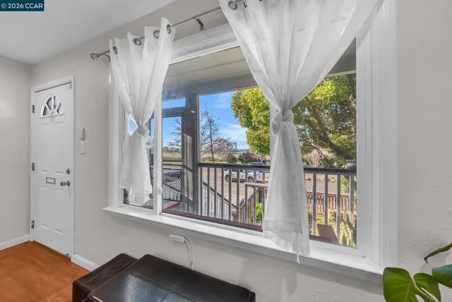 a view of entryway with wooden floor and door