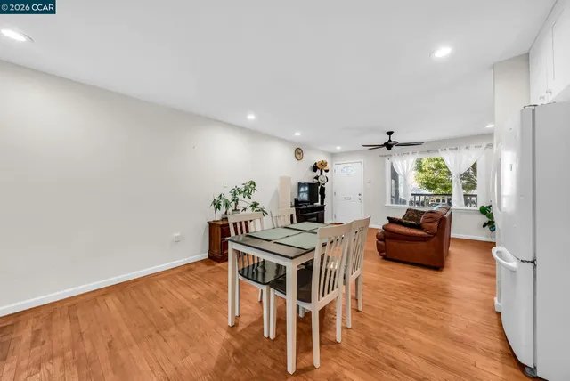 a dining room with furniture and wooden floor